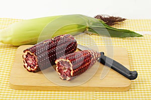 Purple corn fruits on chopping board