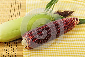 Purple corn fruits on napery