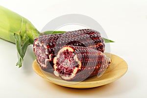 Purple corn  on wooden plate.