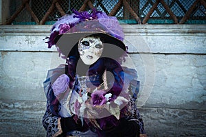 Purple costumed masked woman