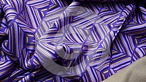 Purple cotton fabric with geometric patterns. Viscose, cotton. Multi-colored bright summer fabric.