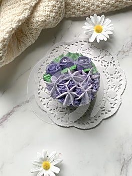 Purple cupcakes decorated with floral theme