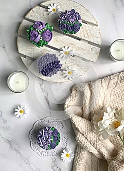 Purple cupcakes decorated with floral theme