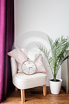 Purple drapes, cozy armchair, pillows and tv stand in living room