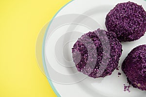 Purple dumplings with plums on yellow background