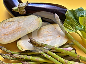 purple eggplants, natural products from the garden, harvest from the plot, cut eggplant, green asparagus, pak choi cabbage