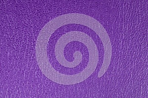 Purple embossed decorative leatherette texture background, close up