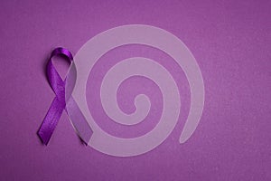 Purple epilepsy awareness ribbon on a purple background with copy space. World epilepsy day photo