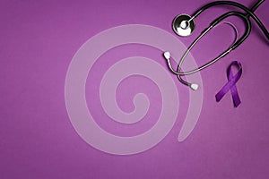 Purple epilepsy awareness ribbon with stethoscope and copy space on a purple background. World epilepsy day photo