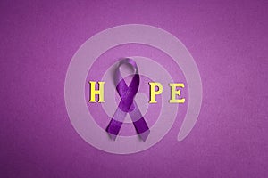 Purple epilepsy awareness ribbon with word hopr on a purple background. World epilepsy day