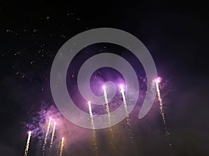 Purple fireworks trail in the night sky
