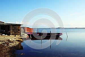 Purple fishing boat in tranquil waters