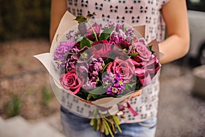 Purple flower bouquet composition in hands