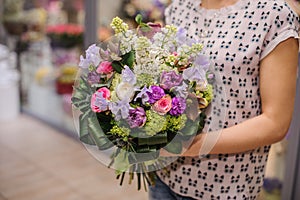 Purple flower bouquet composition in hands