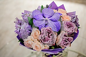 Purple flower bouquet composition on table