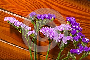 Purple flowers on a decorative wood background