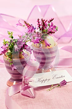 Purple flowers in egg cups for Easter