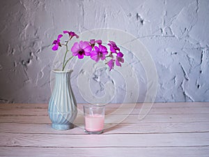 Purple flowers in vase on the table,Purple-pink flower orchids still life background or wallapper cooktown ,Dendrobium bigibbum ma