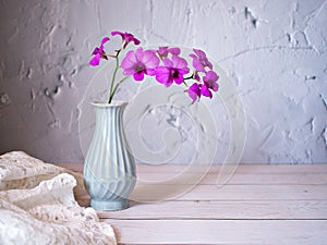 Purple flowers in vase on the table,Purple-pink flower orchids still life background or wallapper cooktown ,Dendrobium bigibbum ma