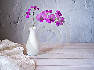 Purple flowers in vase on the table,Purple-pink flower orchids still life background or wallapper cooktown ,Dendrobium bigibbum ma