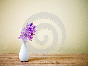 Purple flowers in vase on the table,Purple-pink flower still life on texture background or wallpaper Common water hyacinth Eichhor