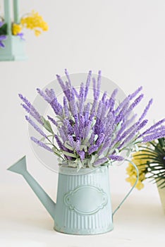 Purple flowers in a watering can