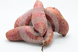 Purple fresh sweet potato on white