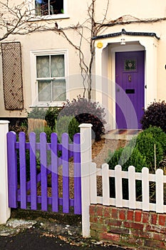 Purple gate and front door on an old Georgian English house