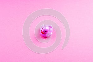 Purple glamour rubber duck on pink background