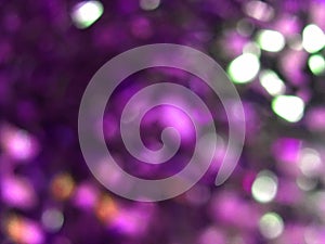 Purple glitter lights background. defocused