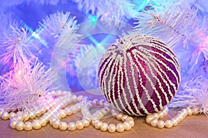 Purple glitter striped Christmas bauble with natural pearl garland