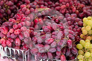 Purple grapes on the market, of the variety Red Globe Seedless. Top view. Close-up