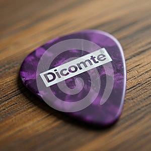 A purple guitar pick with a marbled pattern and the brand name 