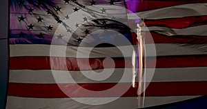 Purple Heart Medal for Military Merit Against Slow Motion American Flag Background.