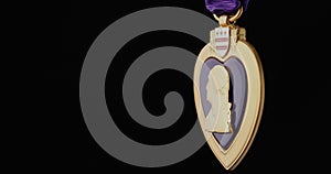 Purple Heart Medal for Military Merit Slowly Rotating On Black Background