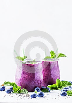 Purple homemade yogurt or smoothie with blueberries, chia seeds
