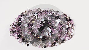 Purple jewel stones heap turning over white, loop ready