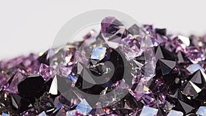 Purple jewel stones heap turning over white, loop ready