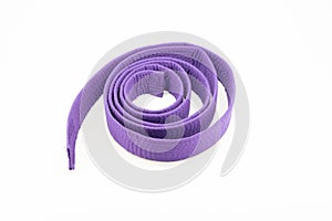 Purple karate belt on white background photo