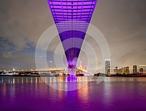 Purple led light under the bridge over the river On a cloudy day in the sky. Bhumibol Bridge, Samut Prakan, Thailand