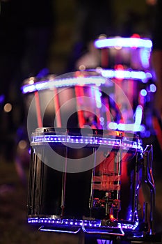 Purple LED lights on snare drums at night