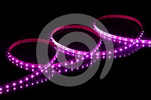 Purple LED strip tape on black background