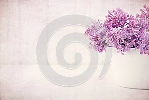 Purple lilac spring flowers on vintage textured background