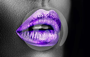 Purple lipstick closeup. Violet metal lips. Beautiful makeup. Sexy lips, bright lip gloss paint