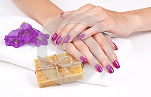 Purple manicure, herbal soap, flowers