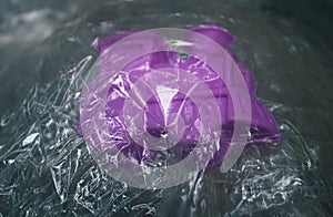 Purple object inside thin plastic film