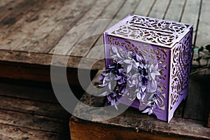 purple open gift box on wooden floor