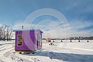 Purple and Orange Ice Fishing Cabins in Ste-Rose Laval