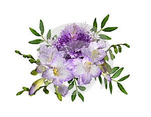 Purple ornamental kale and freesia flowers with green decorative leaves in a floral arrangement isolated