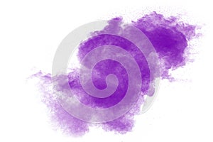Purple particles explosion on white background.Freeze motion of purple dust splash on background